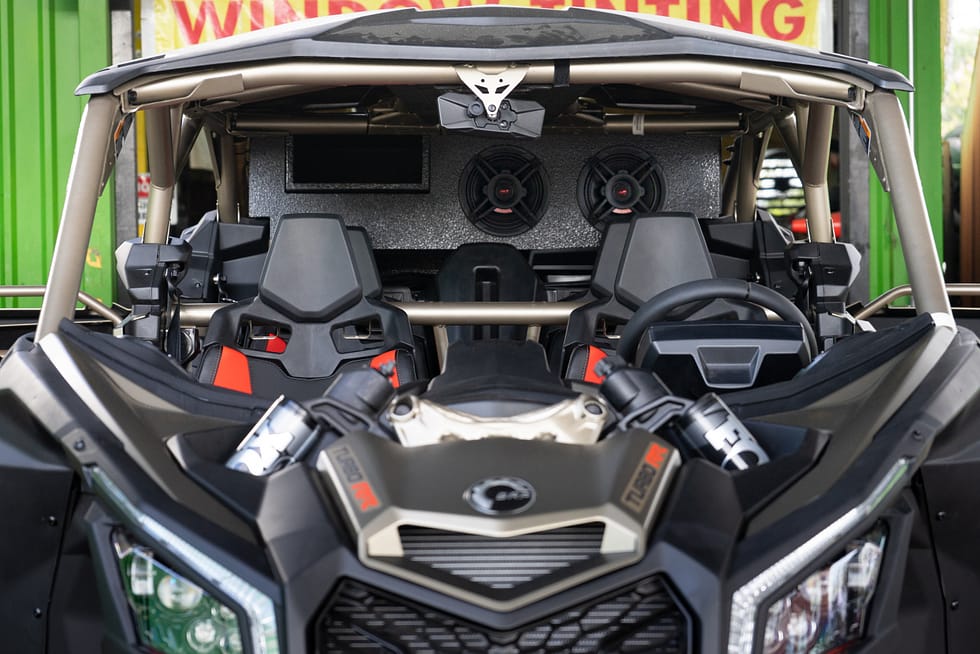 Can-Am Maverick X3 UTV that has a lift kit installed with aftermarket wheels and tires.